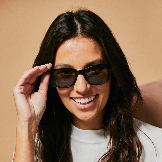 Female model wearing black Tama orca sunglasses from Ozeano Vision